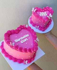 two heart shaped birthday cakes sitting on top of each other