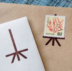 an envelope with a stamp on it next to a piece of paper that says nippon