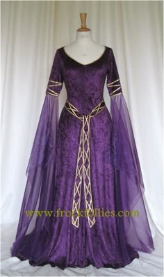 EVE, CELTIC IN INSPIRATION, ELEGANT AND FLOWING IN DEEP PURPLE CRUSHED VELVET WITH GOLD TRIM IS DESIGNED AND CUSTOM MADE BY frockfollies. PERFECT Medieval Wedding Gown With Historical Design, Medieval Wedding Dress With Historical Design, Medieval Floor-length Wedding Dress, Medieval Style Floor-length Wedding Dress, Medieval Wedding Dress, Floor-length, Fitted Medieval Wedding Dress With Historical Design, Fantasy Style Fitted Wedding Gown, Fantasy Style Floor-length Wedding Dress, Fantasy Floor-length Wedding Dress