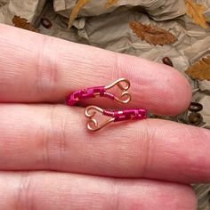 This Vibrant Handcrafted Ring By Autumnleaves Features Raw Copper Wire Beautifully Woven With Hot Pink Coated Wire, Forming Delicate Spiral Heart Shapes. The Bold Pink Accents Stand Out Against The Warm Copper, Creating A Playful Yet Elegant Design. With An Adjustable Fit, This Ring Is Both Fashionable And Functional, Offering A Comfortable Fit For Any Size. The Combination Of Copper And Hot Pink Wire Gives This Piece A Unique, Eye-Catching Charm, Perfect For Anyone Who Loves Handcrafted, Artisa Wire Mushroom Ring, Heart Wire Ring, Wire Wrapping Rings, Wire Wrapped Jewelry Rings, Hot Pink Heart, Weaving Wire, Wire Spiral, Mushroom Ring, Woven Ring