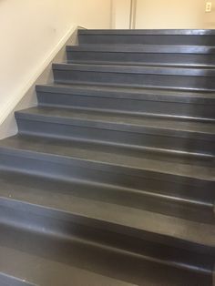 a set of gray stairs leading up to a door