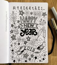 a happy new year coloring book with fireworks and confetti on the page, next to two pens