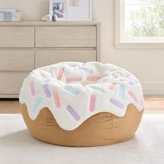 a large donut shaped bean bag chair with sprinkles on the top