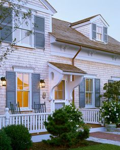 a white house with blue shutters on the front