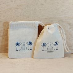 two drawstring bags with palm trees on them