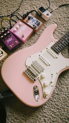 an electric guitar is laying on the floor