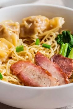 a white bowl filled with noodles and ham