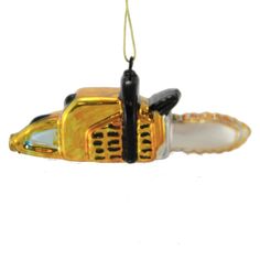 a yellow and black ornament hanging from a string on a white background with an object in the shape of a car