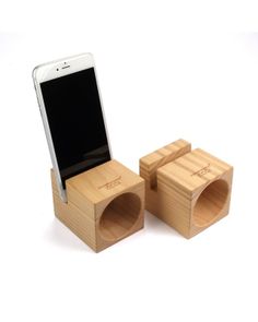 a cell phone is sitting on top of two small wooden boxes that are connected to each other