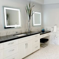 a bathroom with two sinks and mirrors on the wall next to each other in it