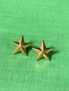 A cute vintage pair of gold tone star stud earrings  Approximately 1/4 of an inch wide Gold Star Earrings For Anniversary, Vintage Gold Star Jewelry, Gold Star Earrings For Formal Occasions, Elegant Gold Plated Star Earrings, Yellow Gold Star Earrings, Everyday Star-shaped Yellow Gold Earrings, Yellow Gold Star-shaped Pierced Earrings, 14k Gold Star-shaped Single Earring, Star Earrings Stud