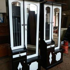 three black and white dressers sitting next to each other in front of a mirror