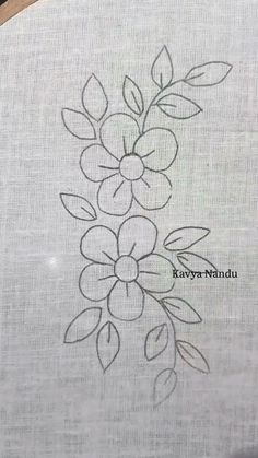 a close up of a piece of cloth with flowers drawn on it and the words kavya nannui written in black ink