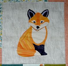 a close up of a quilt with a fox on it