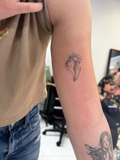 a woman's arm with a tattoo on it and an angel holding a flower