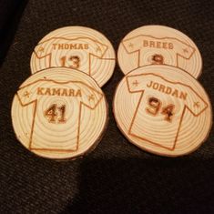 four wooden buttons with the name and number of each team's jersey on them