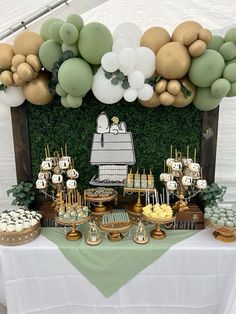 a table topped with lots of desserts and balloons