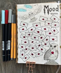 a notebook with an owl and other items on it