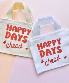 two bags that say happy days ahead and have red lettering on the front one says happy days ahead