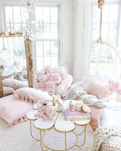 a living room filled with lots of furniture and flowers