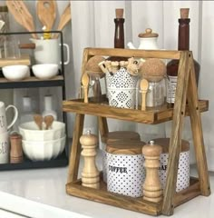 a wooden shelf with various kitchen utensils on it