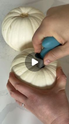 someone is carving pumpkins with a knife