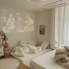 a bed room with a neatly made bed next to a window and a painting on the wall