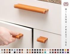 a person is holding the handles on a cabinet