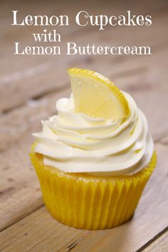 lemon cupcakes with lemon buttercream frosting on a wooden table top