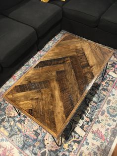 a wooden coffee table sitting on top of a rug