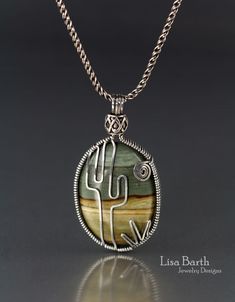 a necklace with a cactus in the center