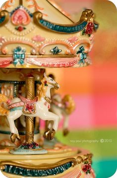 an old fashioned carousel with two horses on it