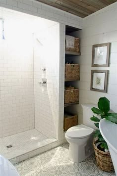 a bathroom with a toilet, sink and shower stall in the corner next to a bathtub