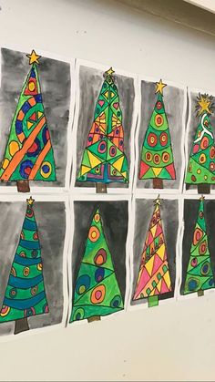 a group of christmas trees painted on white paper