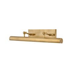 two brass faucets are mounted on the side of a white wall with gold fixtures