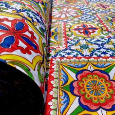 an intricately designed table cloth with colorful designs