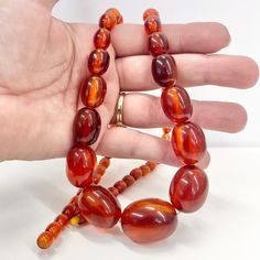 Vintage Art Deco Bakelite bead necklace. A beautiful graduating strand of chunky, oval orange / cherry Amber Bakelite beads. Circa 1930's. Great condition. Details -  Length - 27.5" Largest bead - 30 x 22mm Weight - 65 grams Along with vintage costume jewellery you will also find a huge collection of Uranium, Cadmium, Selenium and Spinel uv reactive jewellery. Please take a look at my other listings. Large Oval Orange Beads, Amber Oval Beaded Necklaces For Jewelry Making, Amber Oval Beads Necklace For Jewelry Making, Amber Beaded Necklace With Large Oval Beads, Amber Beaded Necklaces With Large Oval Beads, Orange Necklace With Large Oval Beads, Orange Necklaces With Large Oval Beads, Deco Orange, Bakelite Necklace