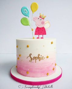 a peppo pig birthday cake with balloons on top