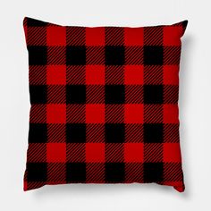 a red and black plaid pillow on a white background