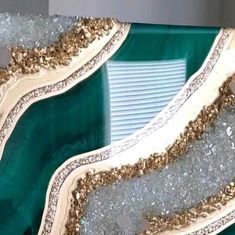 the inside of a green and gold chair with some glitter on it's sides