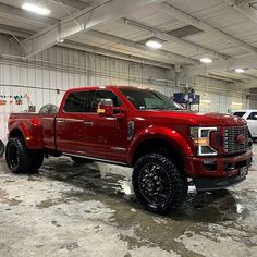 a red truck is parked in a garage