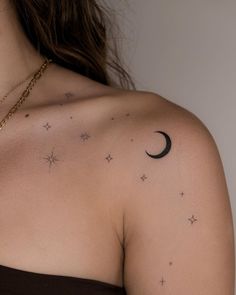 a woman with stars and a crescent tattoo on her chest