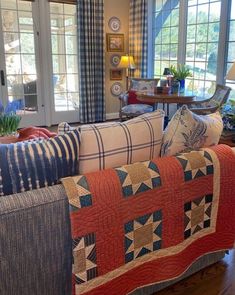 a living room filled with furniture and lots of windows