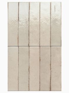 a white tile wall with several different tiles on it