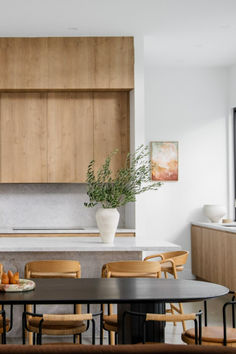 a kitchen with wooden cabinets and tables in it