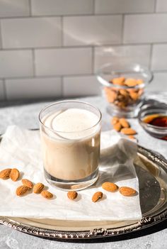 almonds are on the table next to a glass of milk and some other ingredients