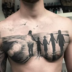 a man's chest with an image of three people and a soccer ball on it