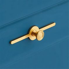 a close up of a door handle on a blue cabinet