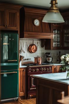 a green refrigerator freezer sitting inside of a kitchen next to a stove top oven