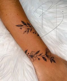 a woman's foot with a flower tattoo on the left side of her leg